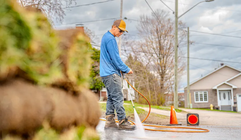 Bouwers crew pressure-washing pavement on a North Bay job site.