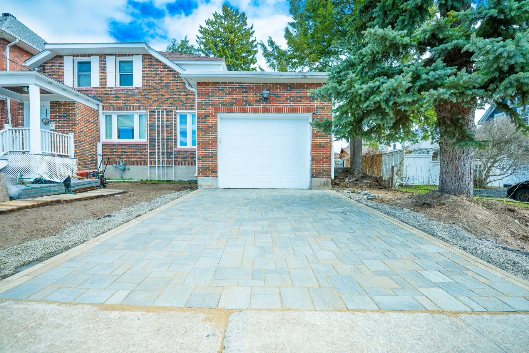 Finished interlock driveway in front of a brick home in North Bay, Ontario.