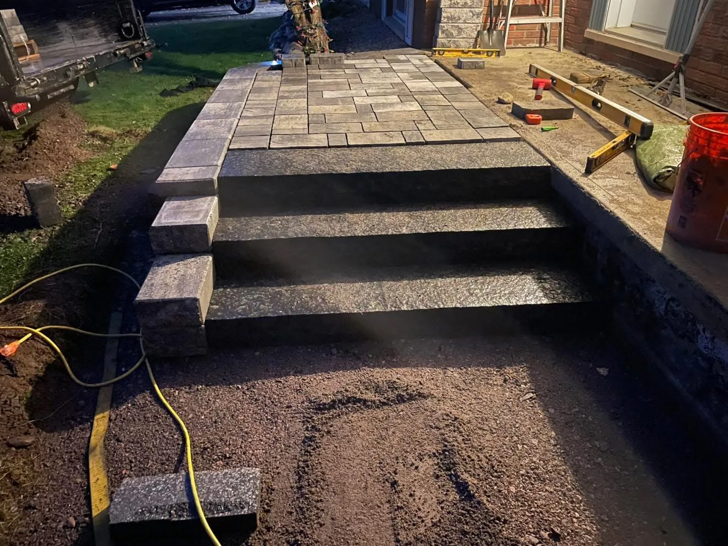 Finished Permacon interlock porch with concrete steps and integrated landing, North Bay.