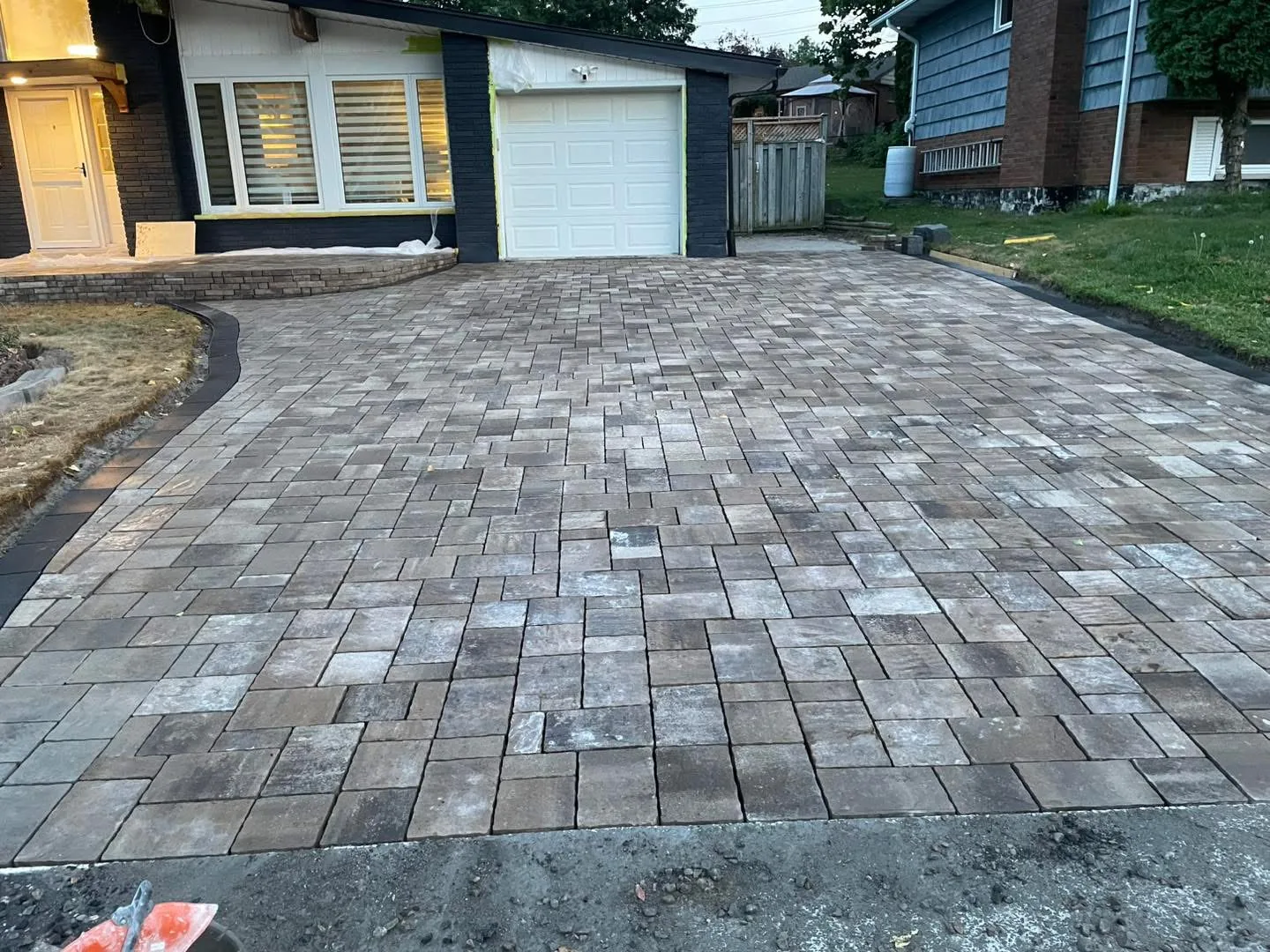 Finished Permacon Trafulgar paver field with Margeau Beige border installed by Bouwers Design Landscaping in North Bay, showcasing one of the manufacturer product lines Bouwers specifies.